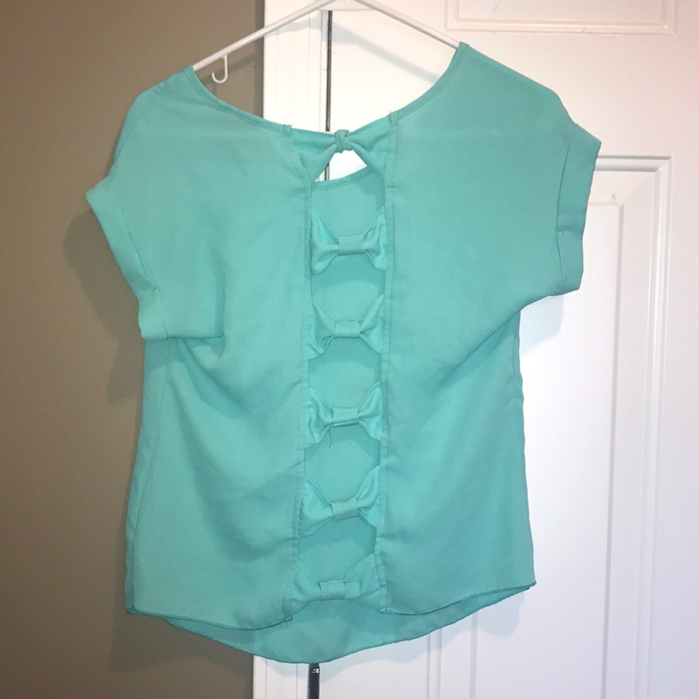 Teal top with bows down the back.